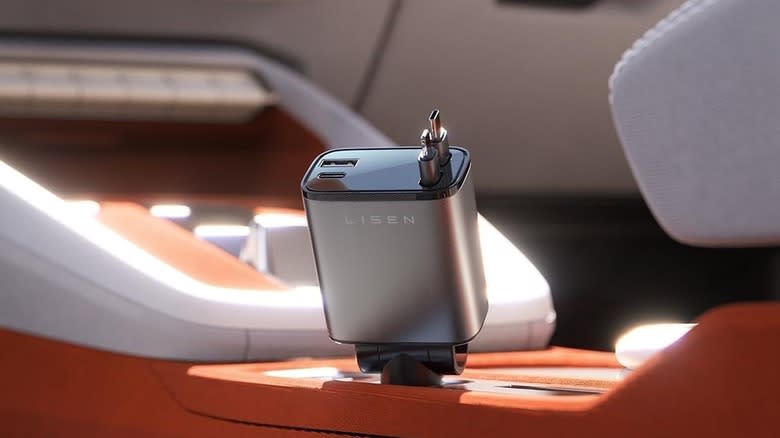 The Lisen Retractable Car Charger plugged into the 12V port of a car's center console.