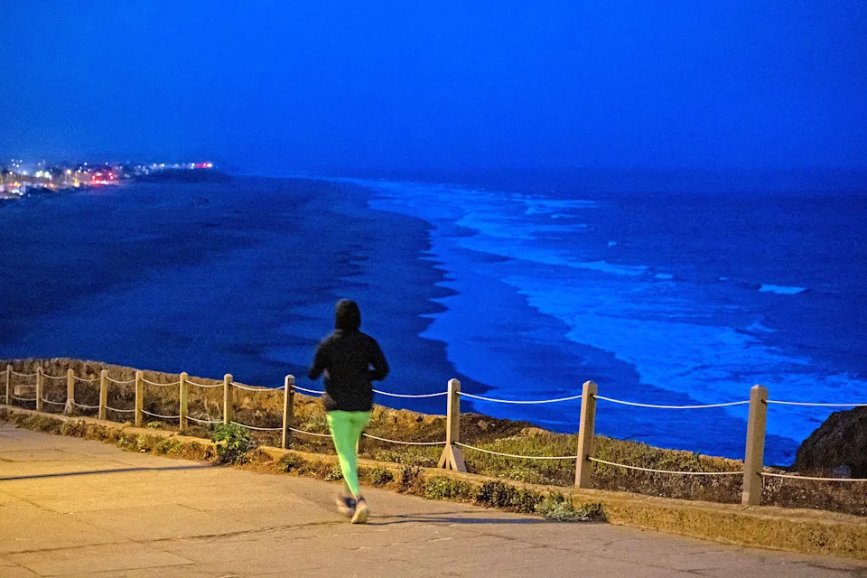 A person exercises along Ocean Beach, after authorities warned residents of the possibility of tsunami waves, following an earthquake at Russia's Kamchatka Peninsula, in San Francisco, California (Carlos Barria / Reuters)