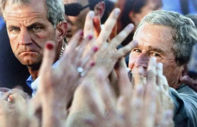 PAUL J.RICHARDS/AFP via Getty Secret Service Agent and George W. Bush