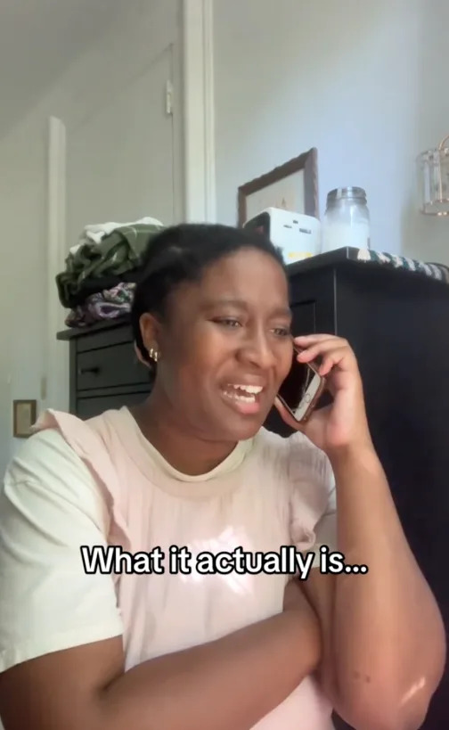 Person talking on phone, smiling, wearing casual shirt, inside a room. Text on image: "What it actually is..."