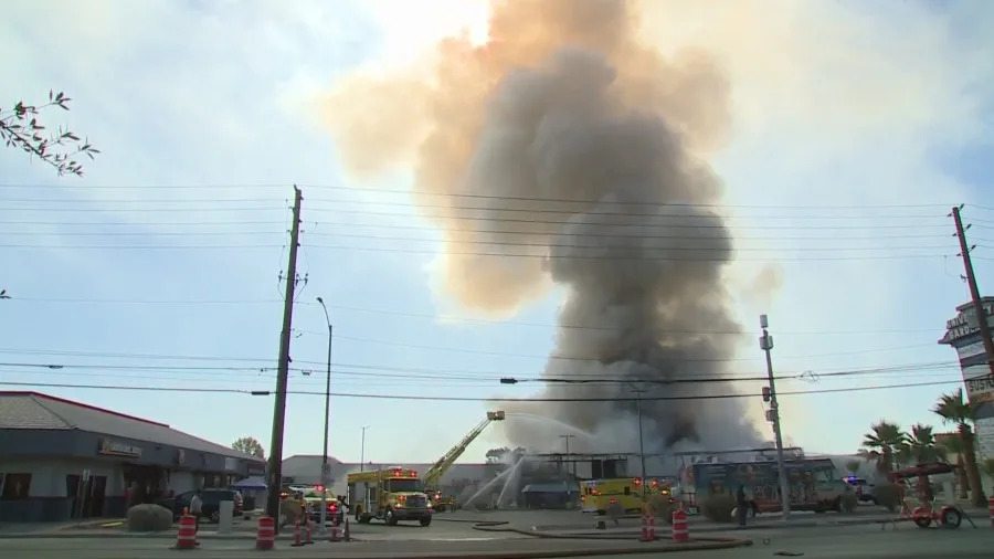 Clark County fire crews battle a large blaze at a business complex across the street from the UNLV campus on Maryland Parkway, near Tropicana Avenue on July 25, 2025. (KLAS)