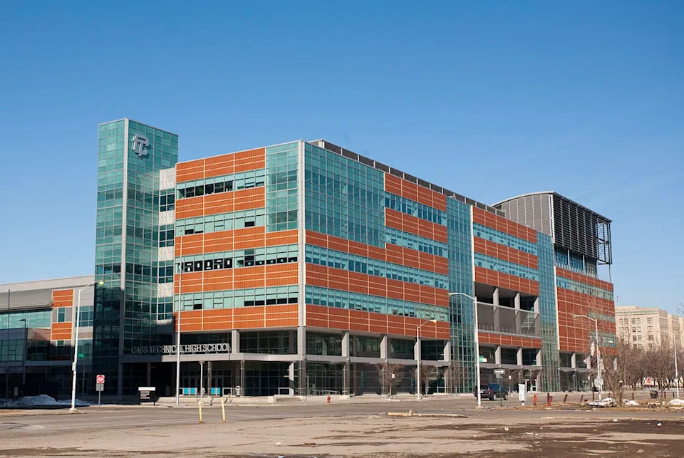A modern-looking multi-story building made from glass and red cladding materials