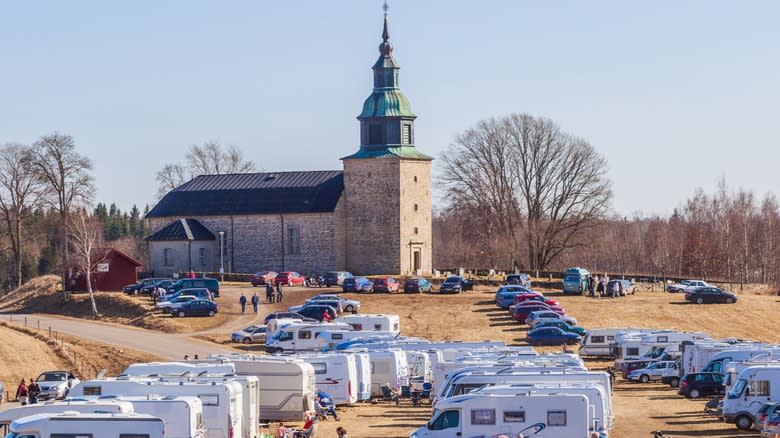 RVs and other vehicles parked in front of a church