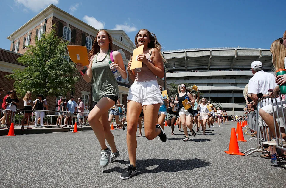 New members of sororities run to their prospective house as they leave Bryant-Denny Stadium during the University of Alabama's Panhellenic Bid Day on Saturday, Aug. 19, 2017. Of the 2,589 young women that participated in UA's Panhellenic Fall recruitment, 2,338 received bids for one of the 16 sororities during UA's annual Bid Day in Tuscaloosa.  [Staff Photo/Erin Nelson]