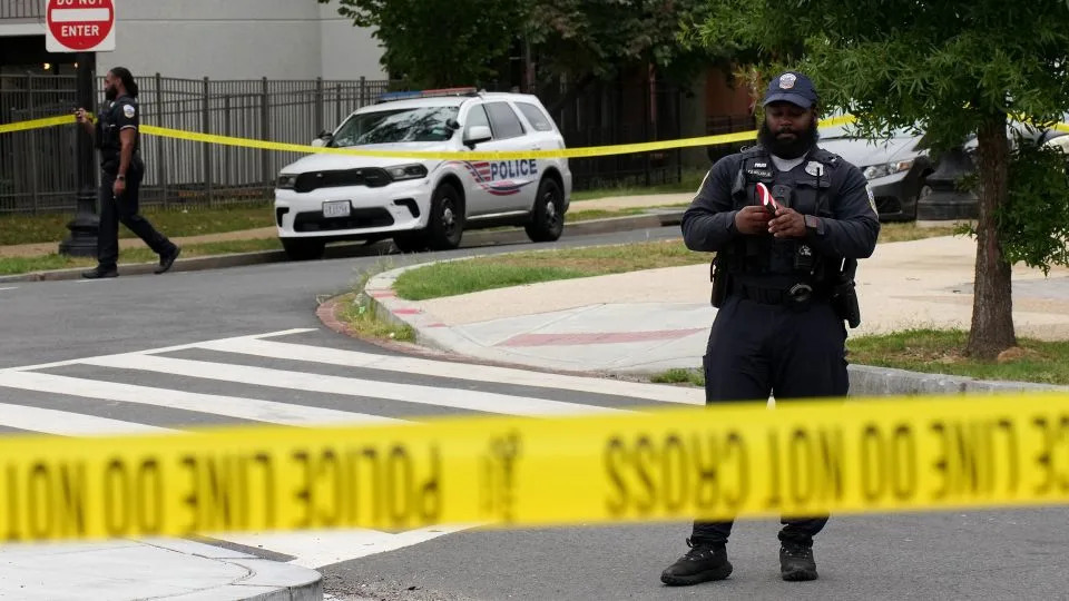 An officer with the Metropolitan Police Department collects evidence at a shooting on H Street Northeast in Washington, DC, on August 21, 2025. - Kevin Dietsch/Getty Images/File