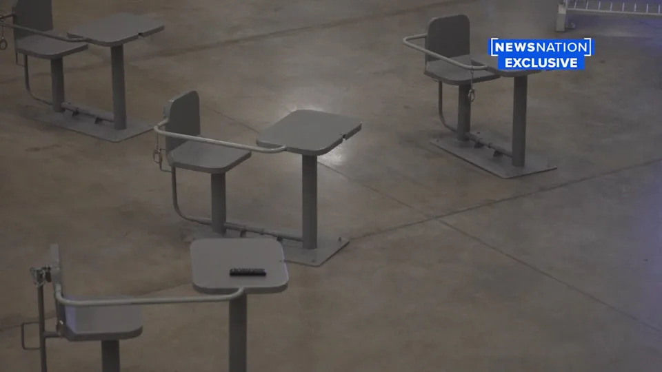 They are allowed to sit at tables outside their cell but are either cuffed to the table or placed inside a cage, where they can use tablets for visitation.