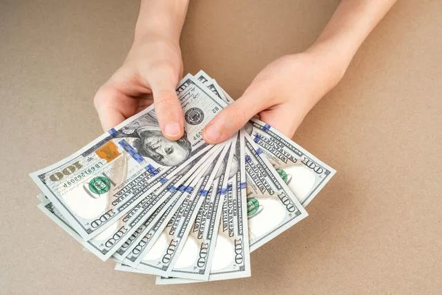 Getty Man counting money (stock image)