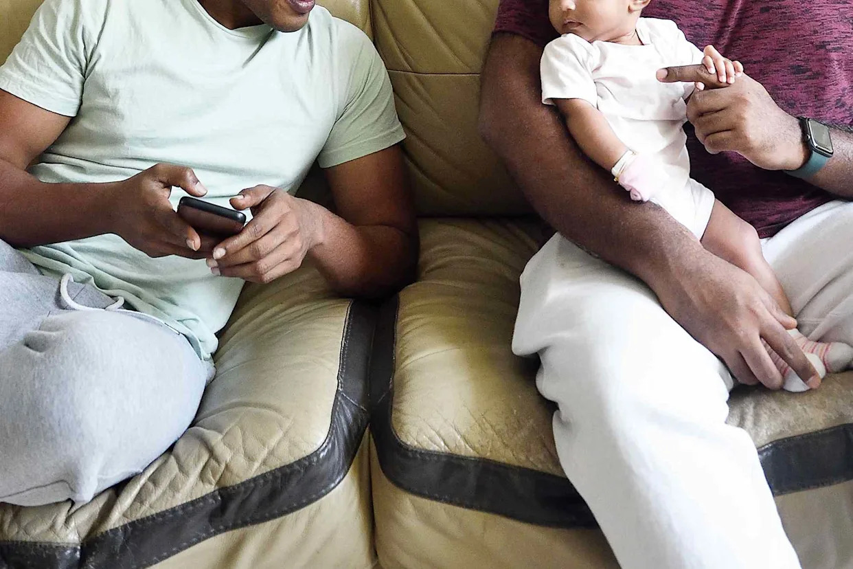 Getty Stock image of two men with a baby