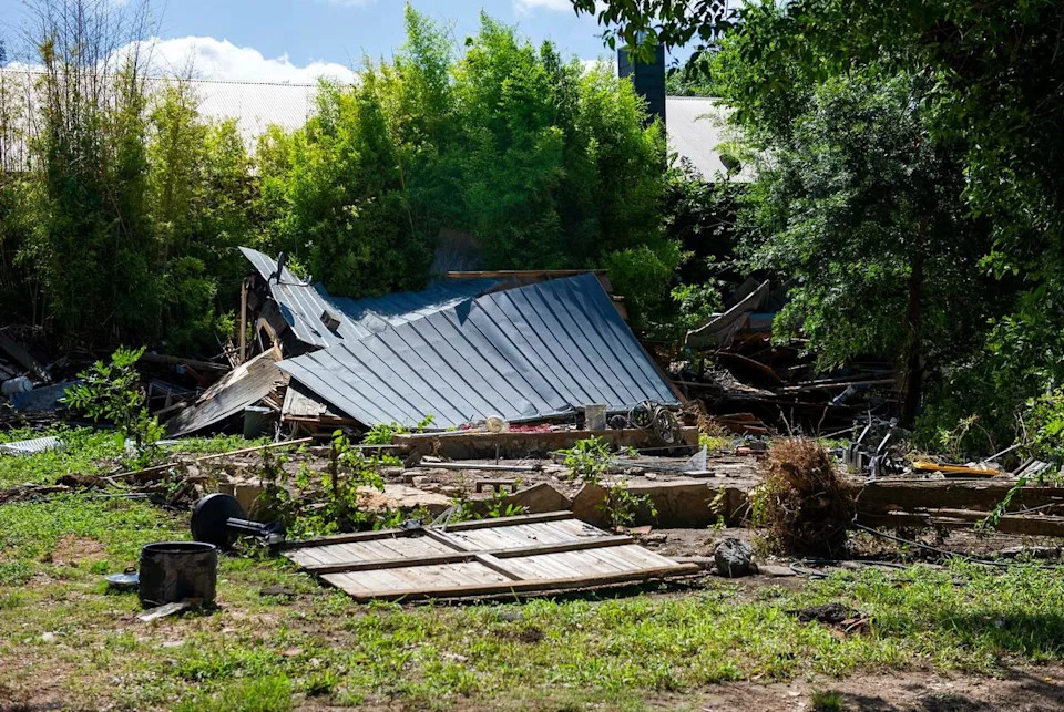 A fallen roof and debris is seen on the banks of the Guadalupe River after intense flooding Tuesday July 8, 2025 in Ingram, Texas.