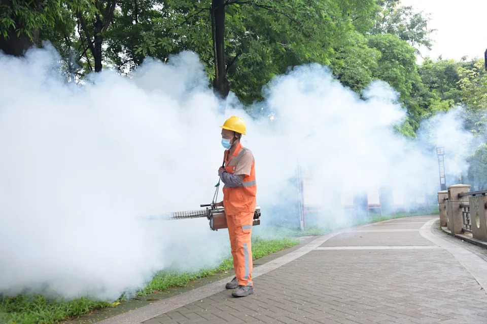 VCG via Getty Images - PHOTO: A sanitation worker sprays insecticide to prevent the spread of Chikungunya on August 3, 2025 in Dongguan, Guangdong Province of China.