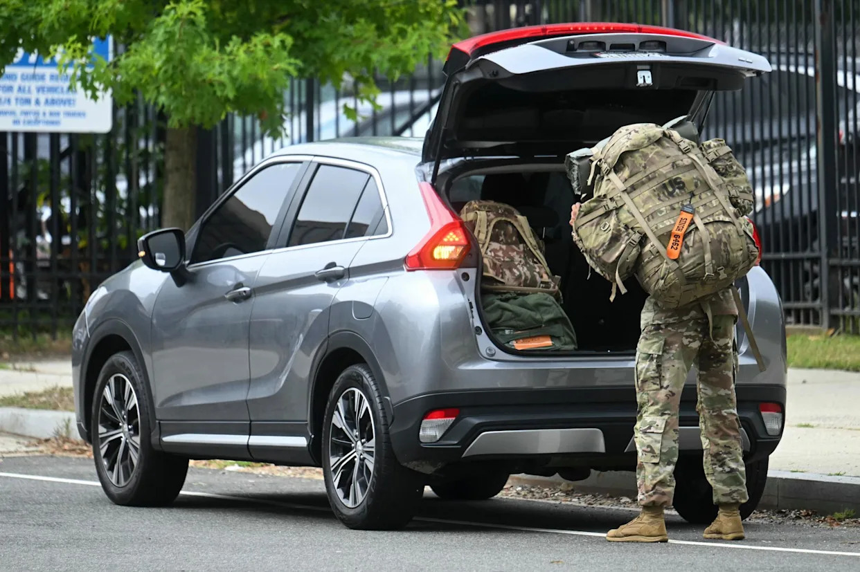 <span>A member of the national guard arrives at the DC Armory in Washington DC on Tuesday.</span><span>Photograph: Jim Watson/AFP/Getty Images</span>