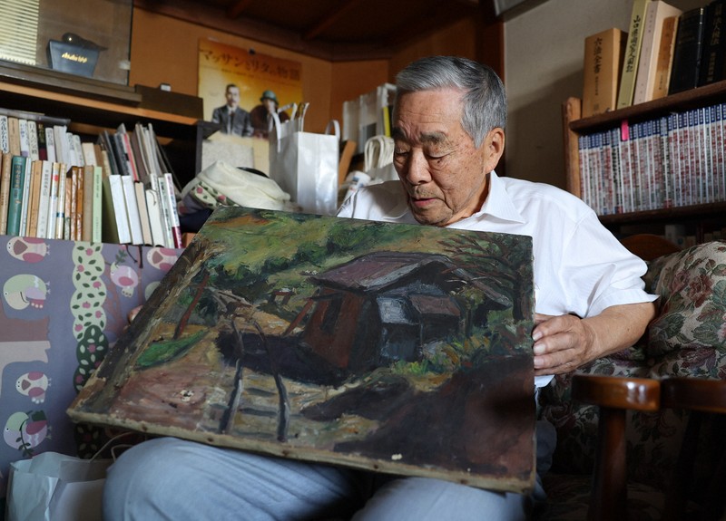 戦死した兄・原田新が描いた絵を手にする茂さん＝山口県周南市で2025年7月19日、猪飼健史撮影