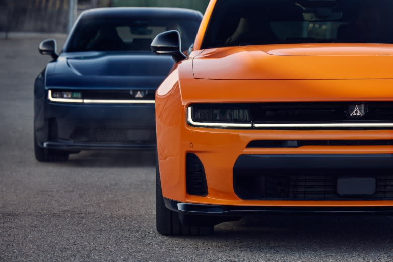 Front ends of an orange and blue Dodge Charger