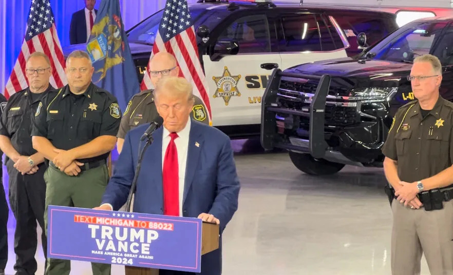 Livingston County Sheriff Mike Murphy (right) looks on as former President Donald Trump speaks at “Crime and Safety” press conference in Howell. Aug. 20, 2024. Photo by Jon King.