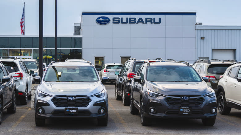 A photograph of a Subaru dealership with many parked cars