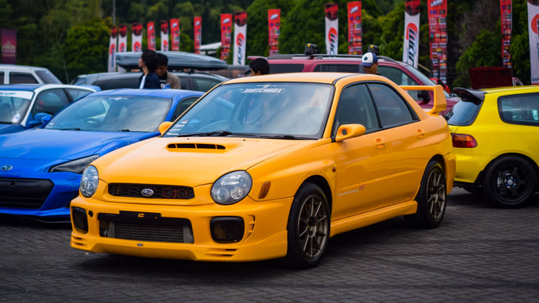 Bandung Indonesia May 11 2024 yellow Subaru Impreza WRX bugeye sedan in JDM Fest 2024 outdoor parking lo