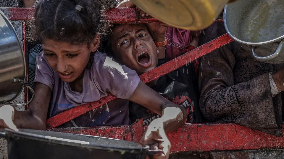 A charity organization distributed food to Palestinians facing severe difficulties accessing basic necessities due to Israel's ongoing blockade and military operations in the Gaza Strip on July 24, 2025. - Ali Jadallah/Anadolu/Getty Images