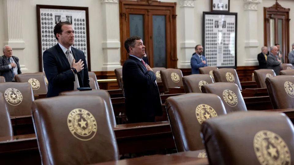 Surrounded by empty seats, Texas lawmakers say the pledge at the state Capitol in Austin on August 4. - Nuri Vallbona/Reuters