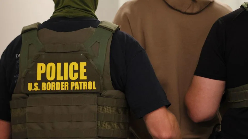 Federal agents detain a man after his court hearing in New York on July 9. - Michael M. Santiago/Getty Images/File