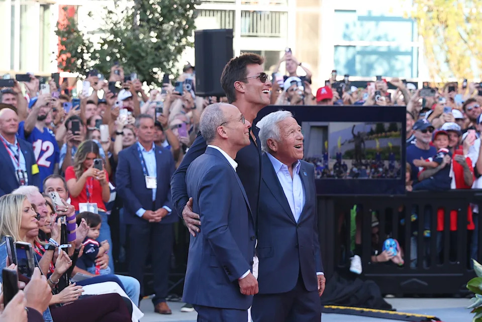 Patriots president Jonathan Kraft, left, and team CEO and owner Robert Kraft, right, share a moment with Tom Brady during the unveiling of the QB legend's statue at Gillette Stadium on Aug. 8. (Photo by M. Anthony Nesmith/Icon Sportswire via Getty Images)