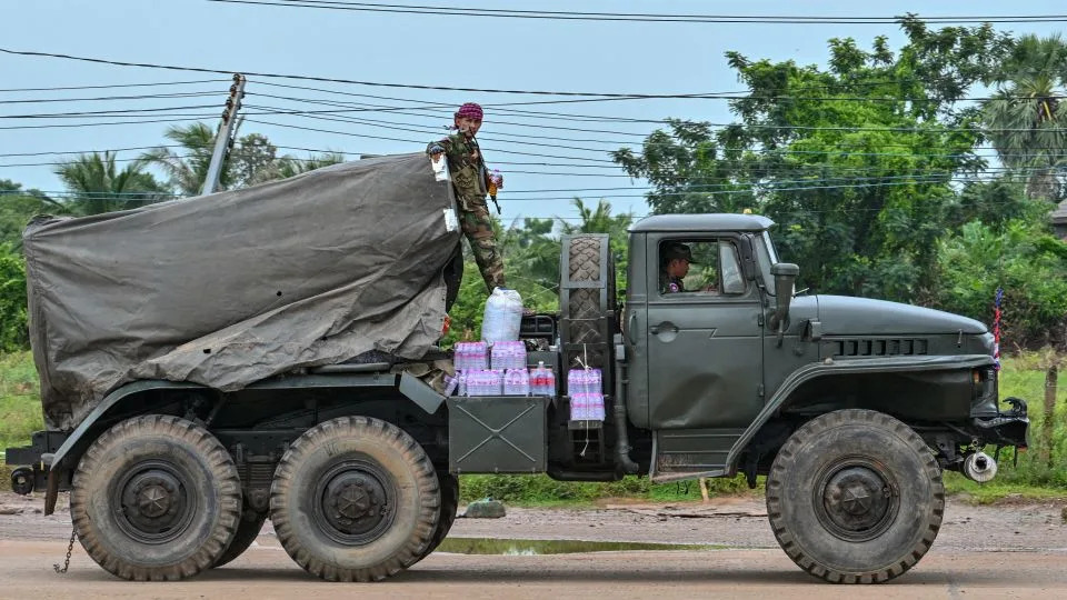 A Cambodian soldier stands on a truck carrying a Russian-made BM-21 rocket launcher travelling along a street in Oddar Meanchey province on July 26, 2025. - Tang Chhin Sothy/AFP/Getty Images