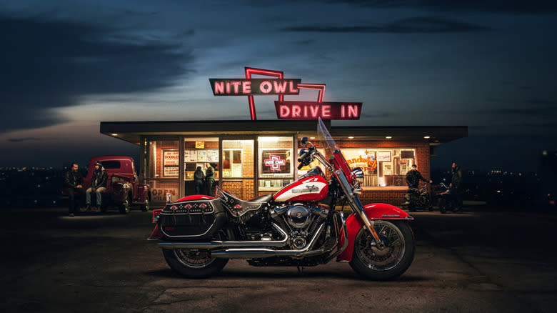 A Harley-Davidson Hydra-Glide Revival motorcycle at night in front of a drive-in diner