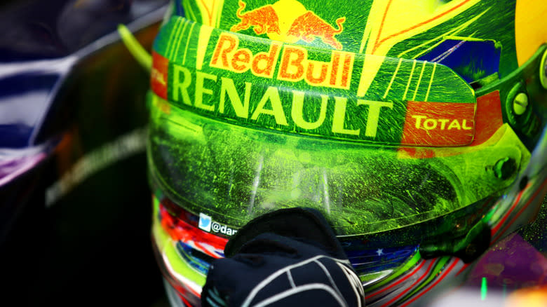 The helmet of Daniel Riccardo with green flow-vis on the front and visor, while sitting in a F1 car.