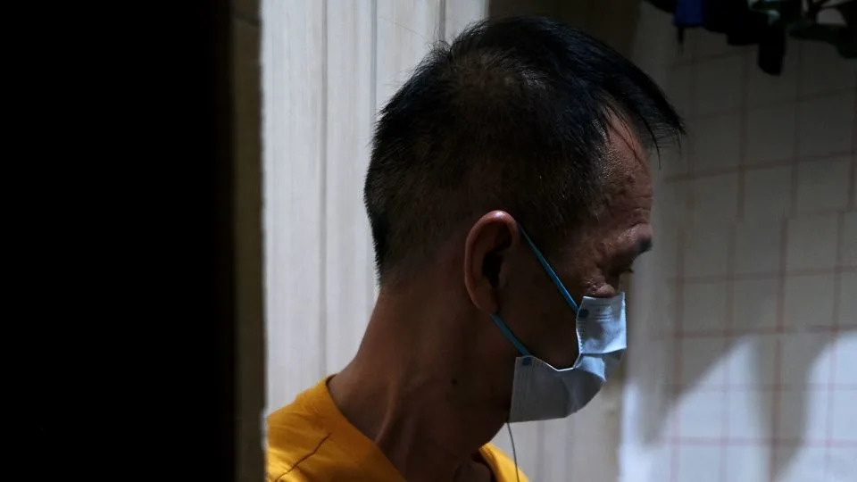 Mr. Tse in his home at a subdivided flat in Sham Shui Po, Hong Kong, on July 3, 2025. - Catherine Phillips/CNN