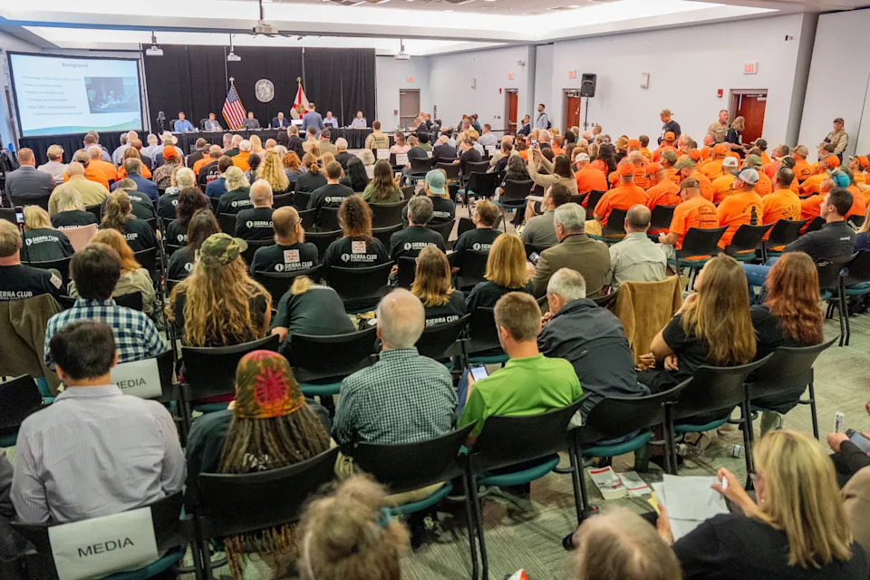 Floridians show whether they are in opposition of the proposed bear hunt by wearing black to the Florida Fish and Wildlife Conservation Commission meeting or by wearing orange in support of it Wednesday, Aug. 13, 2025.