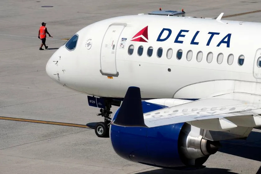 FILE - A Delta Air Lines jet leaves the gate, Friday, July 19, 2024, at Logan International Airport in Boston. Delta Air Lines sued the cybersecurity firm CrowdStrike on Friday, Oct. 25, 2024, saying CrowdStrike caused a global technology outage that cost Delta more than $500 million. (AP Photo/Michael Dwyer, File)