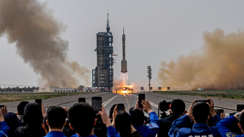 Members from China's Manned Space Agency and visitors watch as the Shenzhou-16 spacecraft onboard the Long March-2F rocket launches at the Jiuquan Satellite Launch Center on May 30, 2023 in Jiuquan, China.