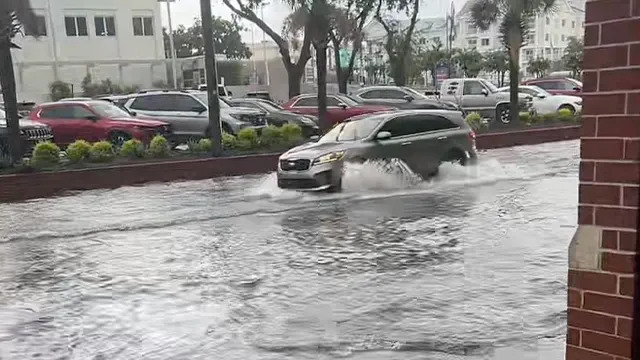 This photo shows a vehicle driving through floodwaters in Charleston, South Carolina, on Aug. 11, 2025.