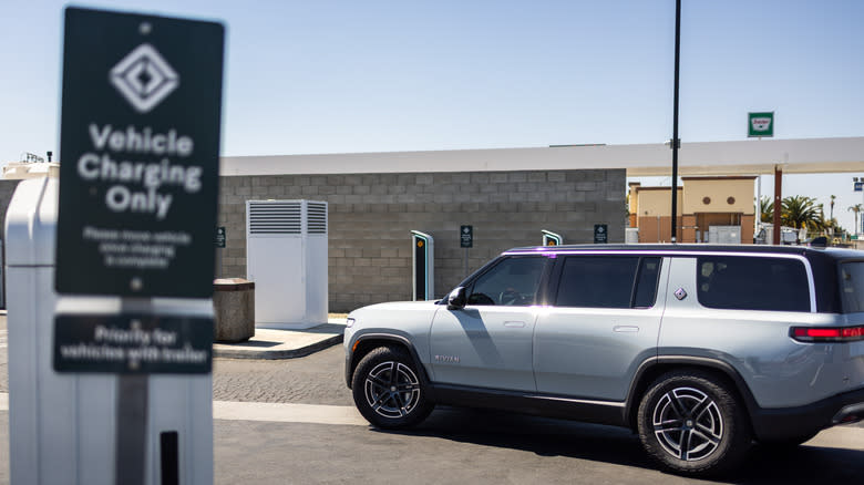 A Rivian R1S SUV is seen in front of a charger that is part of the Rivian Adventure Network charging station on May 10, 2025 in Buttonwillow, California.