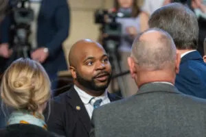  State Sen. Terrell McKinney of Omaha, center, greets Gov. Jim Pillen ahead of the governor’s annual State of the State Address to the Legislature. Jan. 15, 2025. (Zach Wendling/Nebraska Examiner)