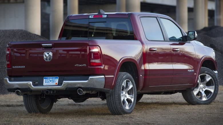 A maroon 2024 Ram 1500 Laramie in front of pillars