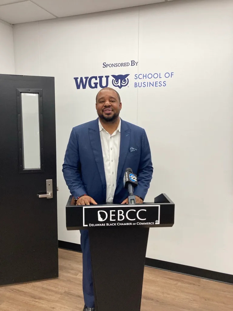 K.L. Allen, regional vice president at Western Governors University, stands at the podium during Delaware Black Chamber of Commerce’s ribbon-cutting ceremony for its new headquarters on Aug. 26 in Wilmington.