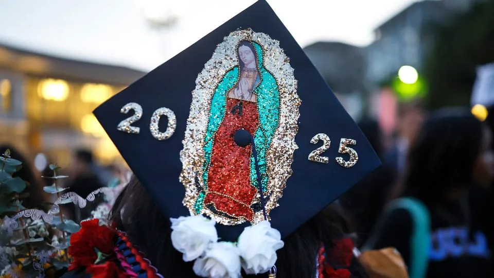 A class of 2025 graduating senior wears a Virgin of Guadalupe image on her cap following the Thurgood Marshall Secondary School graduation ceremony on June 5 in Pasadena. - Mario Tama/Getty Images