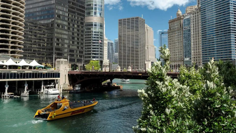 Boats float down the Chicago River in Chicago on Monday. - Jim Vondruska/Reuters