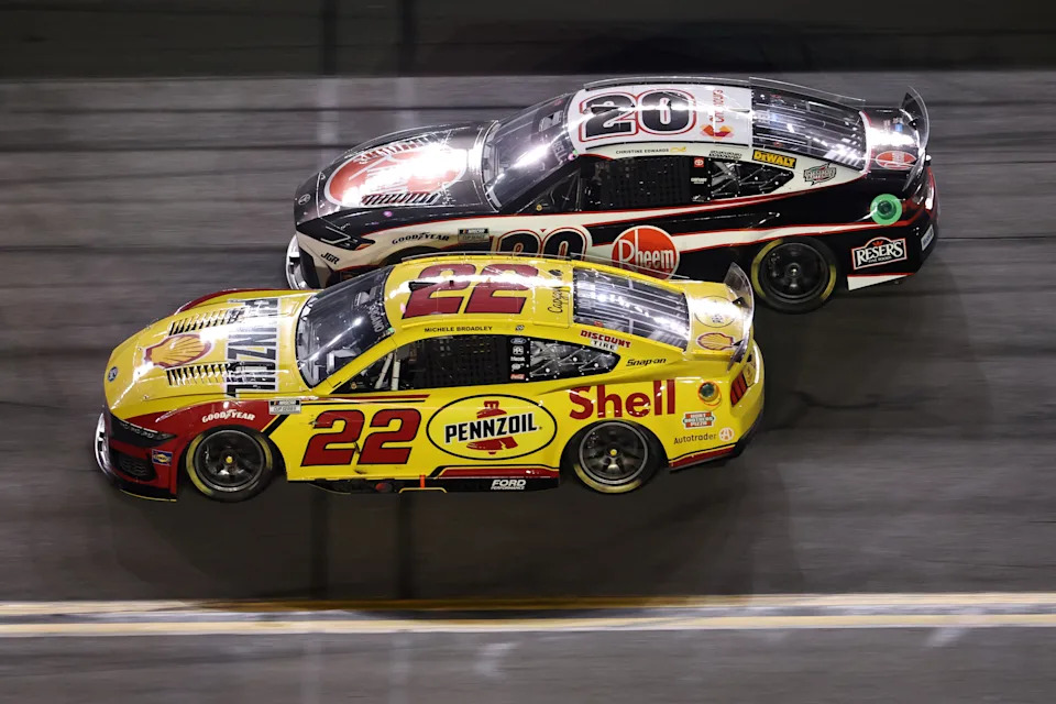 DAYTONA BEACH, FLORIDA - AUGUST 23: Joey Logano, driver of the #22 Shell Pennzoil Ford, races Christopher Bell, driver of the #20 Rheem Toyota, during the NASCAR Cup Series Coke Zero Sugar 400 at Daytona International Speedway on August 23, 2025 in Daytona Beach, Florida. (Photo by Chris Graythen/Getty Images)