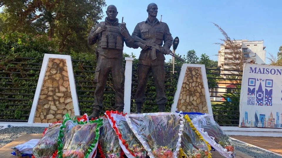 A photograph from 2024 shows a bronze statue depicting Wagner group chief Yevgeny Prigozhin (L) and commander Dmitry Utkin in front of the "Maison Russe" (Russian House) in Bangui, CAR. - Annela Niamolo/AFP/Getty Images