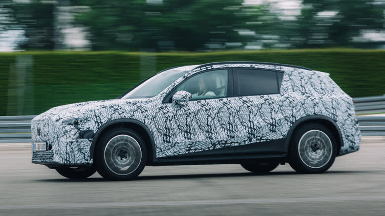 Front 3/4 view of a camouflaged Mercedes-Benz GLC prototype