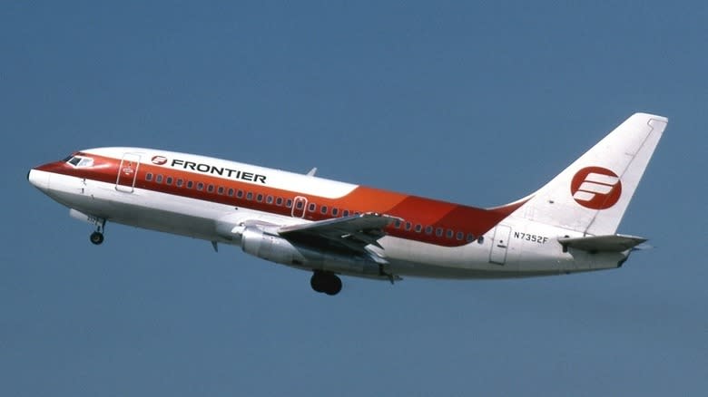 Vintage image of Frontier Airline's Boeing 737 jet in mid-flight