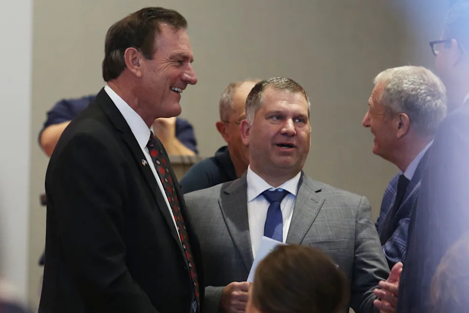 Gov. Larry Rhoden and South Dakota Board of Regents President Tim Rave speak in downtown Sioux Falls on Aug. 14, 2025, before the University of South Dakota's announcement that the state's only medical school will move to Sioux Falls. (Makenzie Huber/South Dakota Searchlight)