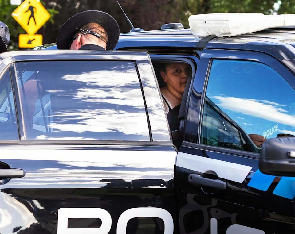 Idaho State Police troopers put Avalon Hardy in a Boise Police Department vehicle after her arrest.