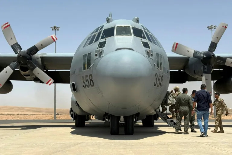 A Royal Jordanian Air Force C-130 Hercules military transport prepares to take off from King Abdullah II airbase with a consignment of aid to airdrop over Gaza. (Ahmad SHOURA)