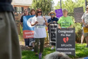 State Sen. Margo Juarez of Omaha, center, speaks during a protest against state plans to turn a prison into a migrant detention facility outside the Nebraska Governor’s Mansion in Lincoln. Aug. 22, 2025. (Photo by Zach Wendling/Nebraska Examiner)