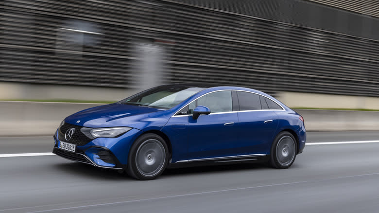 A blue EQE 500 driving on a highway