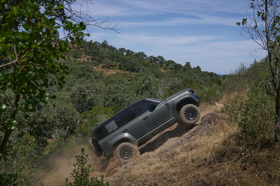 an SUV climbs up a steep hill