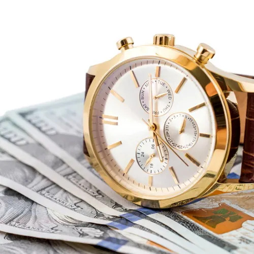 Wrist watch on money.