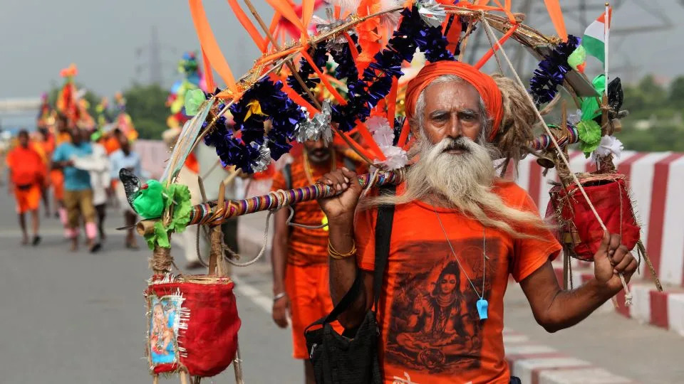 Lord Shiva devotees carry sacred Ganga Jal (holy water) during the ongoing Kanwar Yatra, in New Delhi, India on July 15, 2025. - Naveen Sharma/SOPA Images/LightRocket/Getty Images